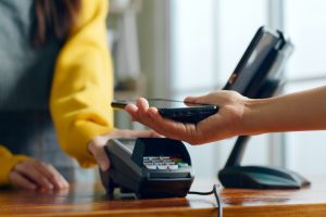 Customer paying with a phone at a card terminal
