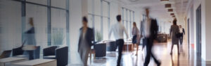 A group of people walking down an office corridor